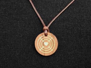 Aiming Art Lucky Charm pendant, 2-tone, on a black sweater